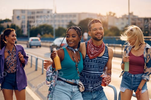 Preview: Carefree couple of festival goers and their friends having fun in summer day.