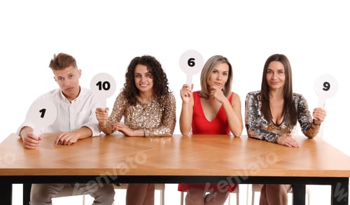 Preview: Panel of judges voting with score signs at table on white background