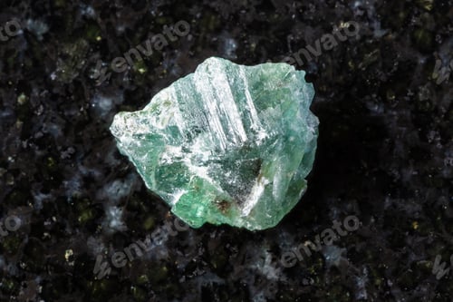 Preview: raw green alexandrite crystal in daylight on black