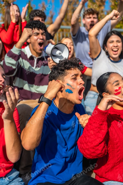 Preview: Enthusiastic sports fans cheering with face paint in stadium