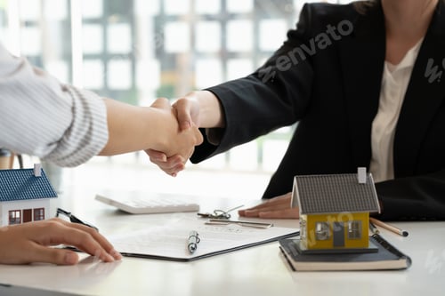 Preview: Real estate broker and customer shaking hands after signing a contract: real estate, home loan and