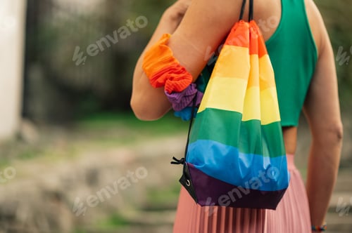 Preview: Woman wearing rainbow backpack showing support for lgbtq plus community