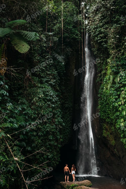 Preview: Couple at a tropical waterfall. The couple travels to the island of Bali in Indonesia