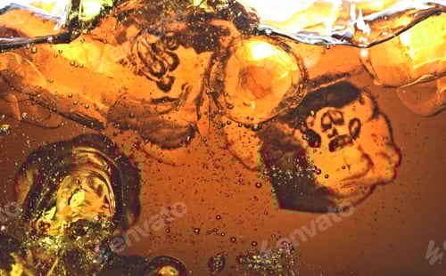 Preview: Golden soda bubbles and ice close-up