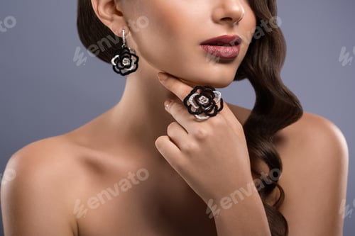 Preview: Gorgeous woman with precious jewelry in studio