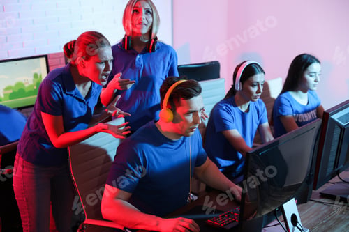 Preview: Young people playing video games on computers indoors. Esports tournament