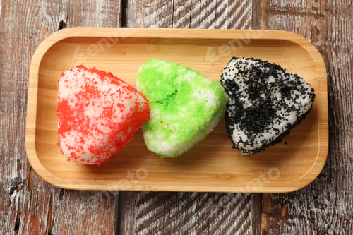 Preview: Tasty tobiko onigiri (Japanese rice balls) served on wooden table, top view