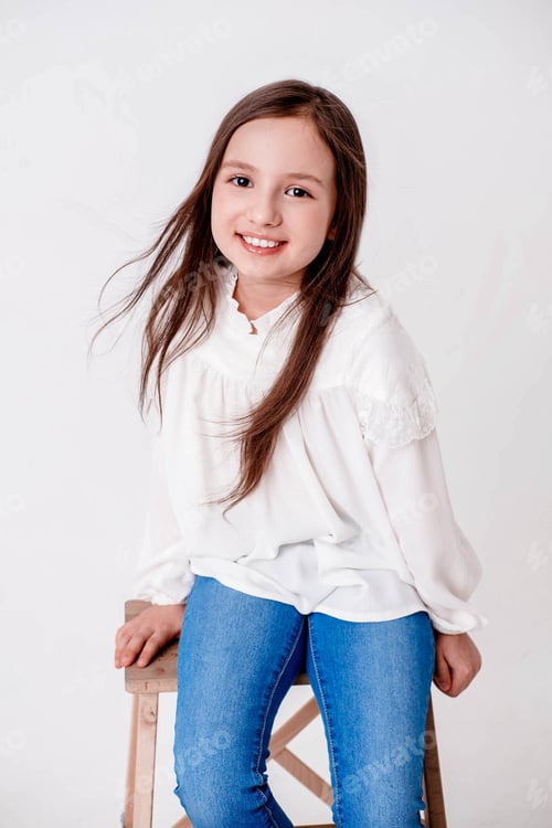 Preview: cute little girl smiling. Portrait of a girl on a white background. Model tests girls