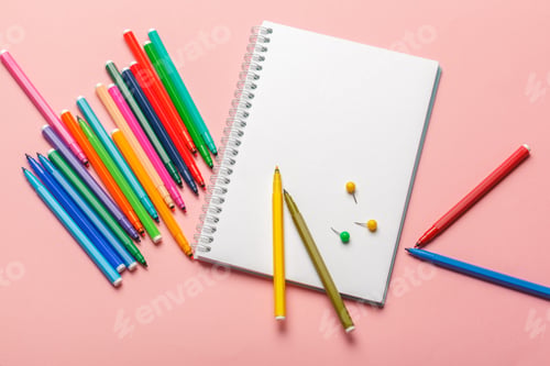 Preview: Colorful felt tip pens with blank notepad paper on pink pastel background