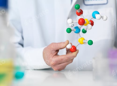Preview: Scientist holding a molecular model of a chemical formula