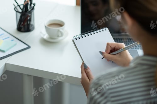 Preview: Business asian hand holding pencil and writing note on wood table,Checklist Notice Remember Planning