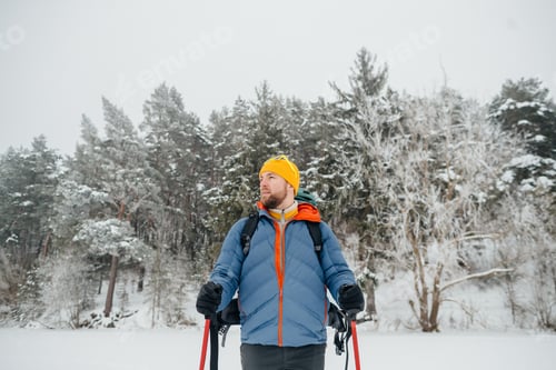 Preview: Man hiking solo in snowy winter forest