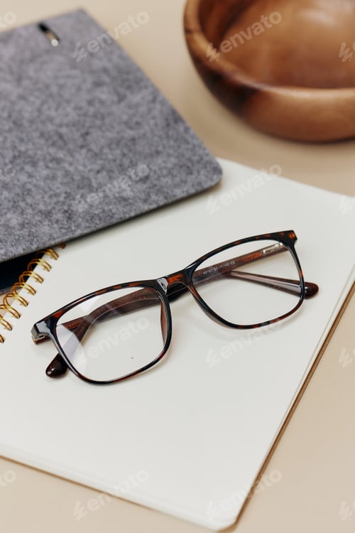 Preview: Eyeglasses on a Spiral Notebook With Grey Case