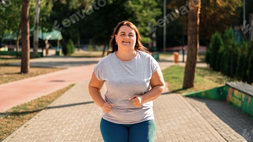 Preview: Woman with overweight running in a park