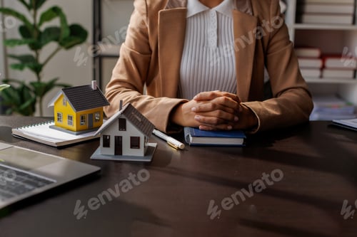 Preview: Business mortgage realtor with house model, sitting at desk, real estate agent manager working on ca