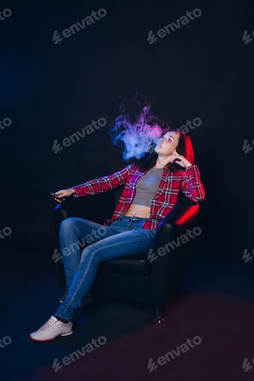 Preview: Vaping. Young Beautiful Woman Smoking Electronic Cigarette With Smoke. Vapor Concept.