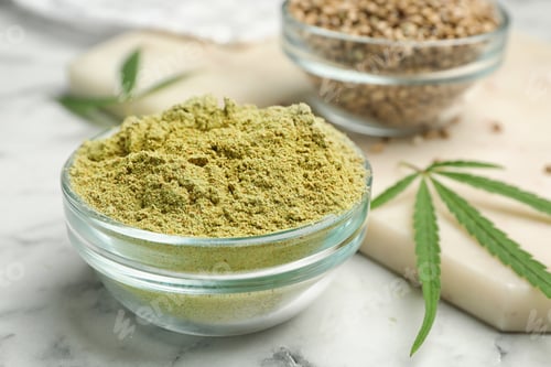 Preview: Bowl of hemp protein powder on marble table, closeup