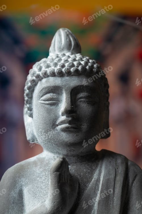 Preview: stone statue of buddha on a stone window sill surrounded by flowers and smoke - asian celebrations