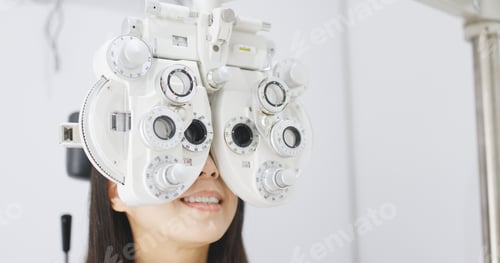 Preview: Asian Woman doing eye test in clinic