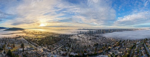 Preview: Panoramic Aerial View of Foggy Sunrise Over Burnaby BC Canada With City Skyline and Suburbs