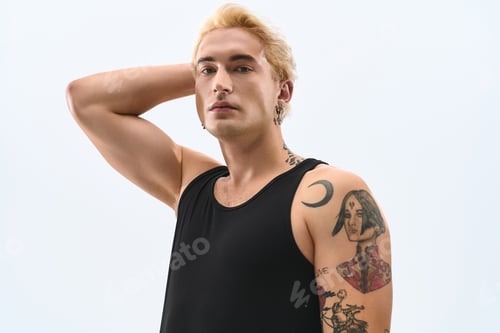 Preview: Handsome young man showcases stylish fashion with confidence and poise in modern setting