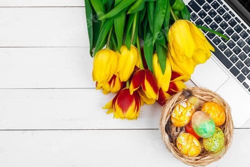 Preview: Easter eggs, mockup laptop and bouquet of tulips