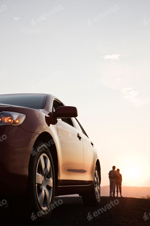 Preview: Senior couple watching a sunset from a rest stop on a road trip in eastern Washington State, USA.