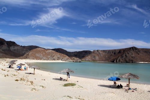 Preview: Beautiful shot of Balandra beach with people lying on the shore on a sunny day