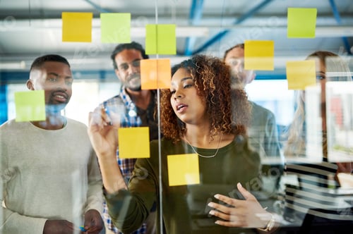 Preview: Shot of colleagues having a brainstorming session with sticky notes at work