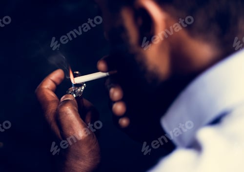 Preview: Rear view of man lighting a cigarette