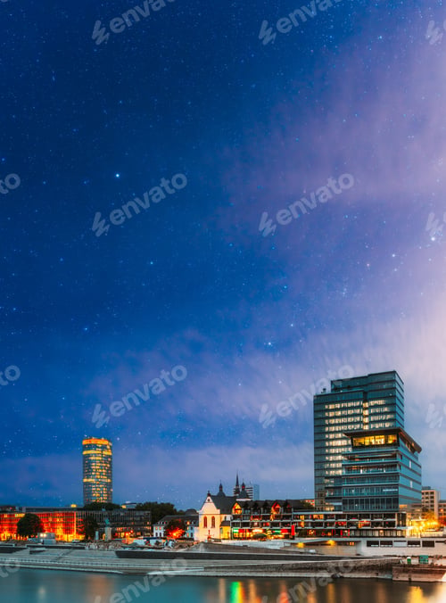 Preview: Cologne, Germany. Modern Building On Embankment During Summer Evening Night