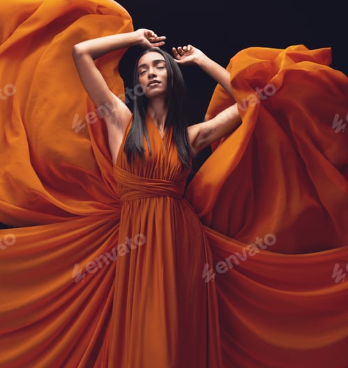 Preview: Fashion, stylish and an Indian woman in a classy dress isolated on a black background in a studio.