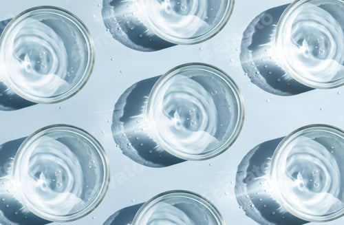 Preview: petri dish with liquid water on plain on a light background water ripple texture