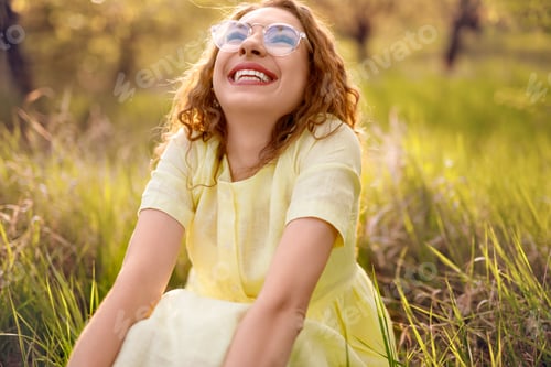 Preview: Excited lady enjoying summer day in meadow