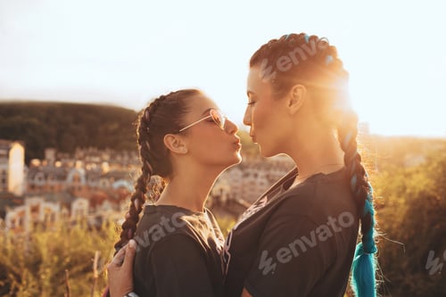 Preview: mother and daughter, embracing, facing the face, at the sunset