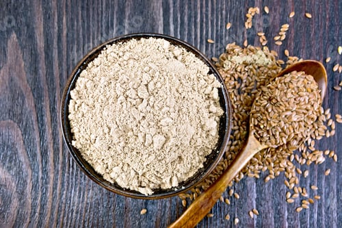 Preview: Flour linen in bowl with seeds in spoon on board top