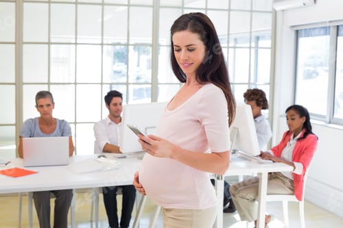 Preview: Pregnant Office Worker Touches Bump And Texts On Phone In The Office
