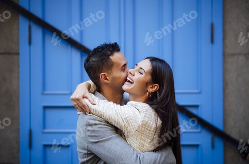 Preview: Happy Caucasian loving couple with a blue door in the background