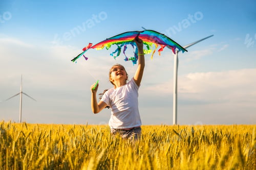 Preview: Happy Little girl running in a wheat field with a kite in the summer.