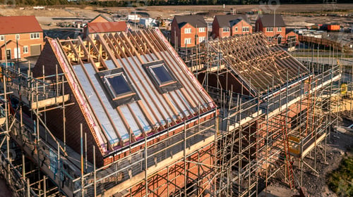 Preview: Aerial view roof under construction with attic room and skylight window on a new housing development