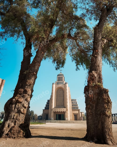 Preview: a large building surrounded by trees next to a road and bridge