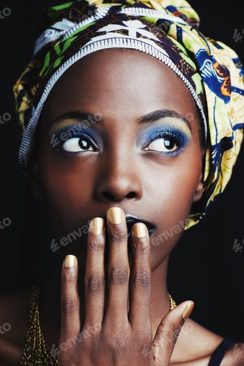 Preview: Shes a true african beauty. A beautiful african woman posing against a black background.