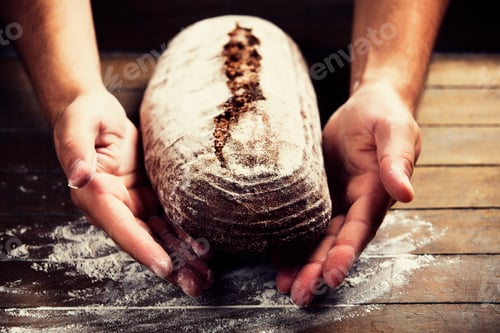 Preview: Baker's hands with a bread