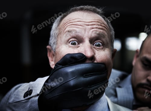 Preview: Portrait of a shocked businessman caught unaware by an assailant in the parkade