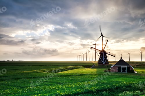 Preview: sunshine behind old windmill and modern mills