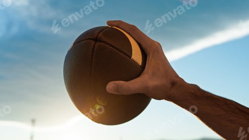 Preview: American football ball at sunset