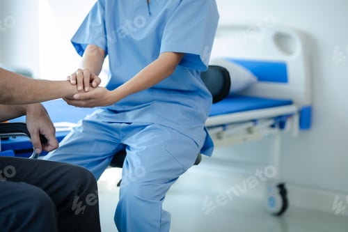 Preview: Male patient sitting in wheelchair undergoing a medical examination with specialist physician, treat