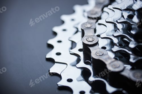 Preview: New rear mountain bike cassette with chain on the black background close up