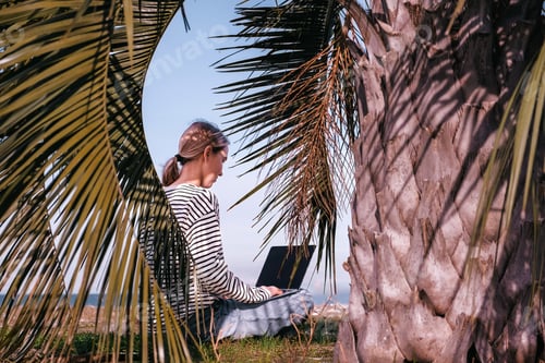 Preview: Remote work.Girl freelancer works remotely sea shore. workation, remote work,leisure, work life bala