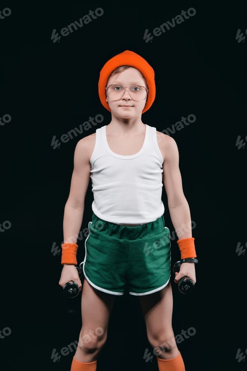 Preview: boy training with dumbbells isolated on black. athletics children concept